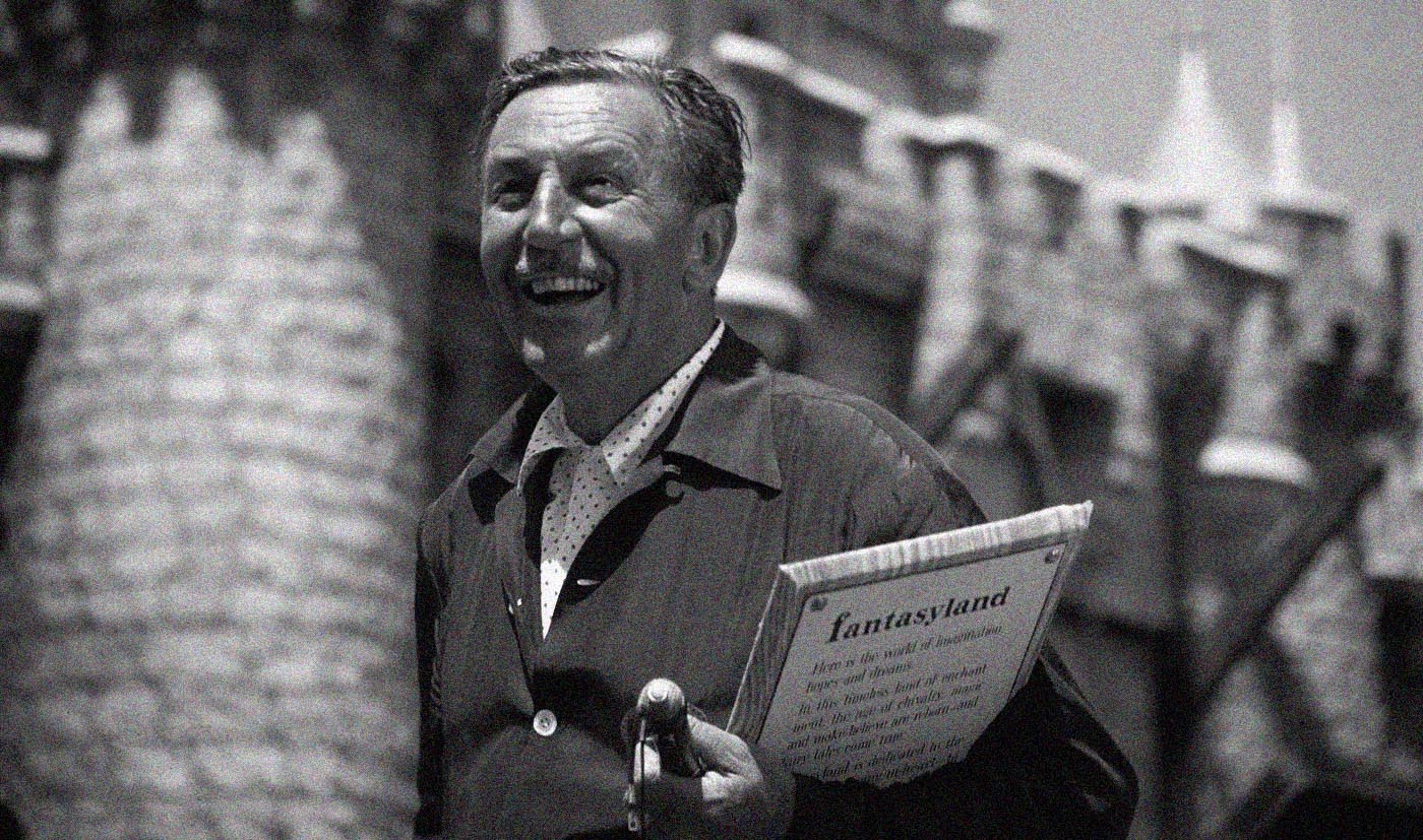 A man smiles while holding a book in his hands, conveying a sense of joy and engagement with reading.