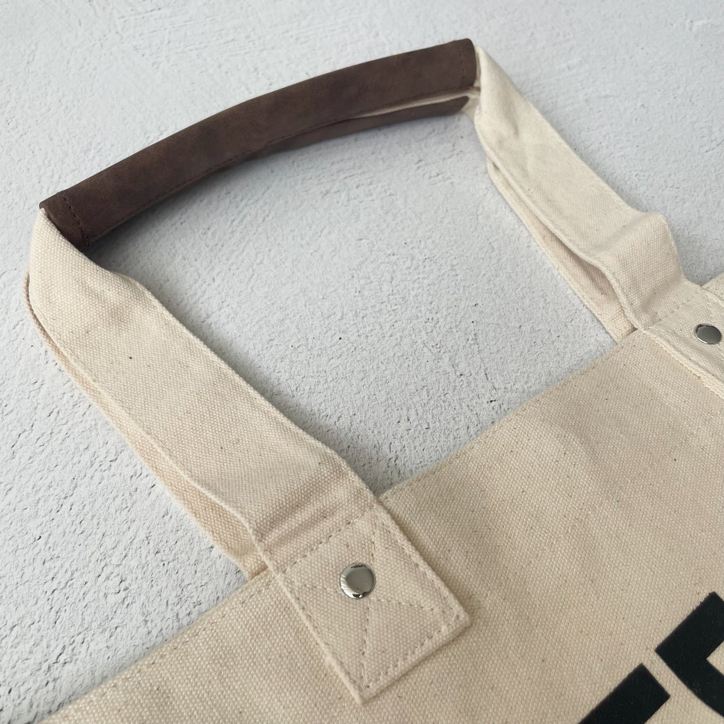 A close up shot of a vintage tote bag handle