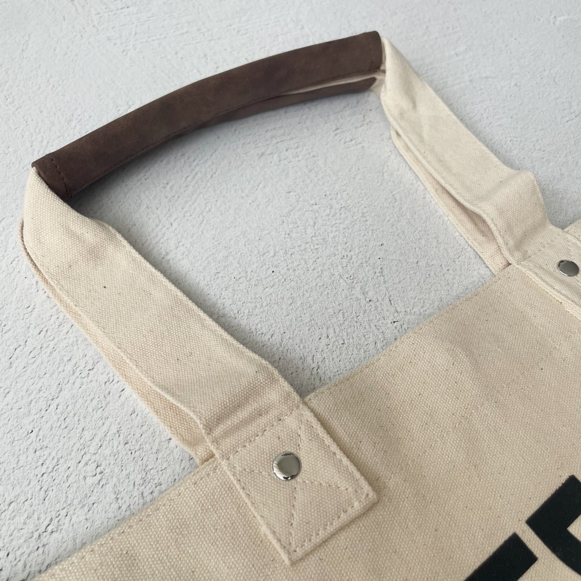 A close up shot of a vintage tote bag handle