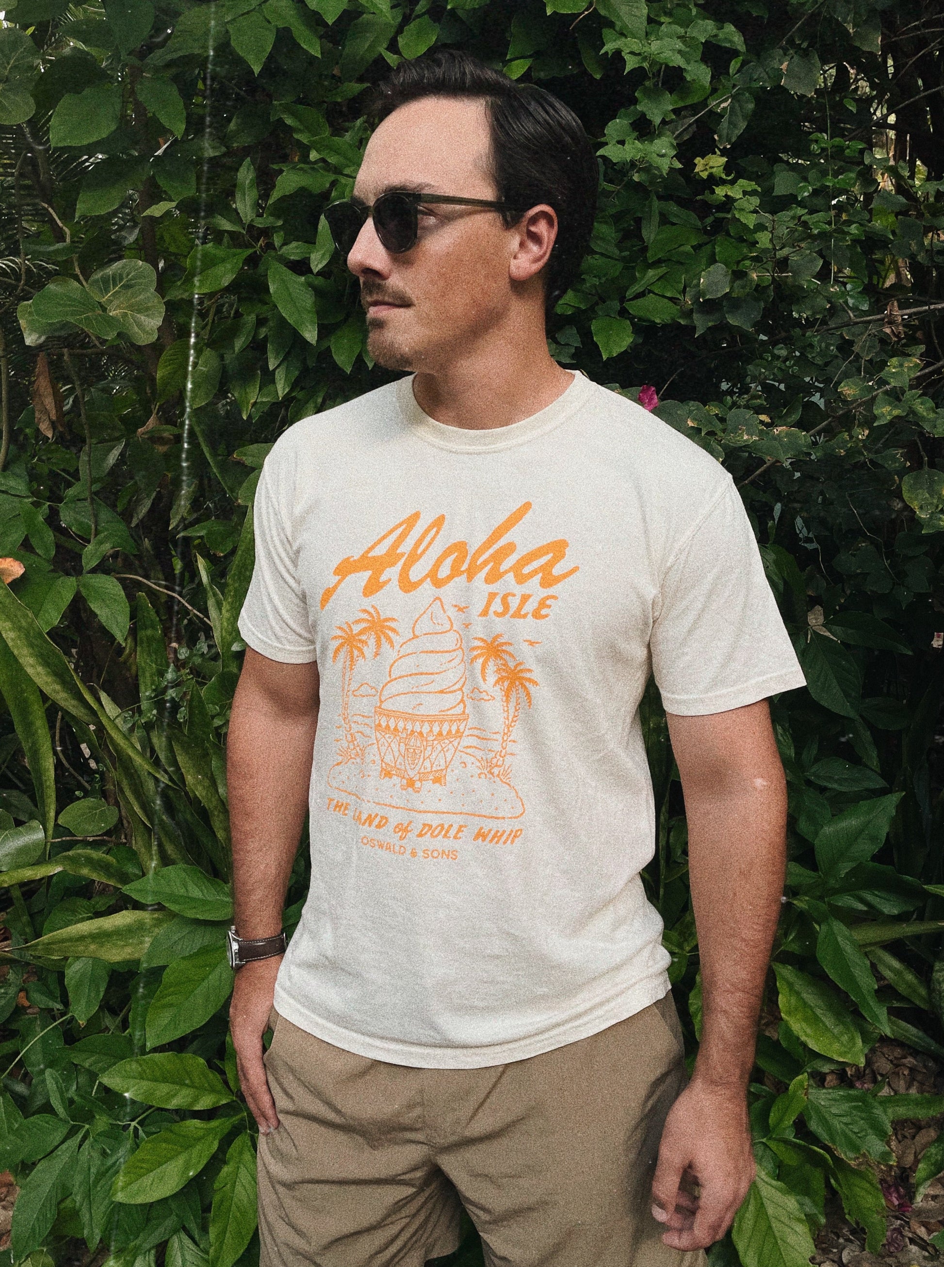 Man wearing an ivory Aloha Isle Dole Whip design t-shirt