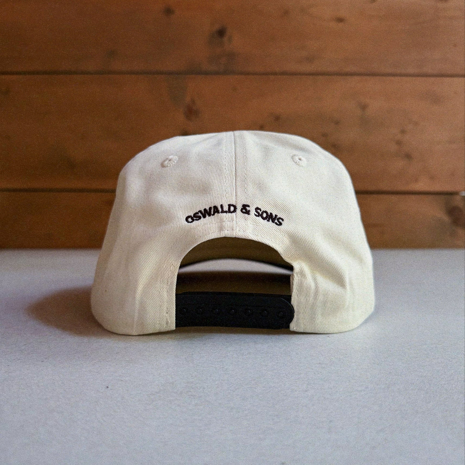 Two-tone natural and black cap with an embroidered patch featuring Oswald The Lucky Rabbit and the phrase 'Make Your Own Luck'