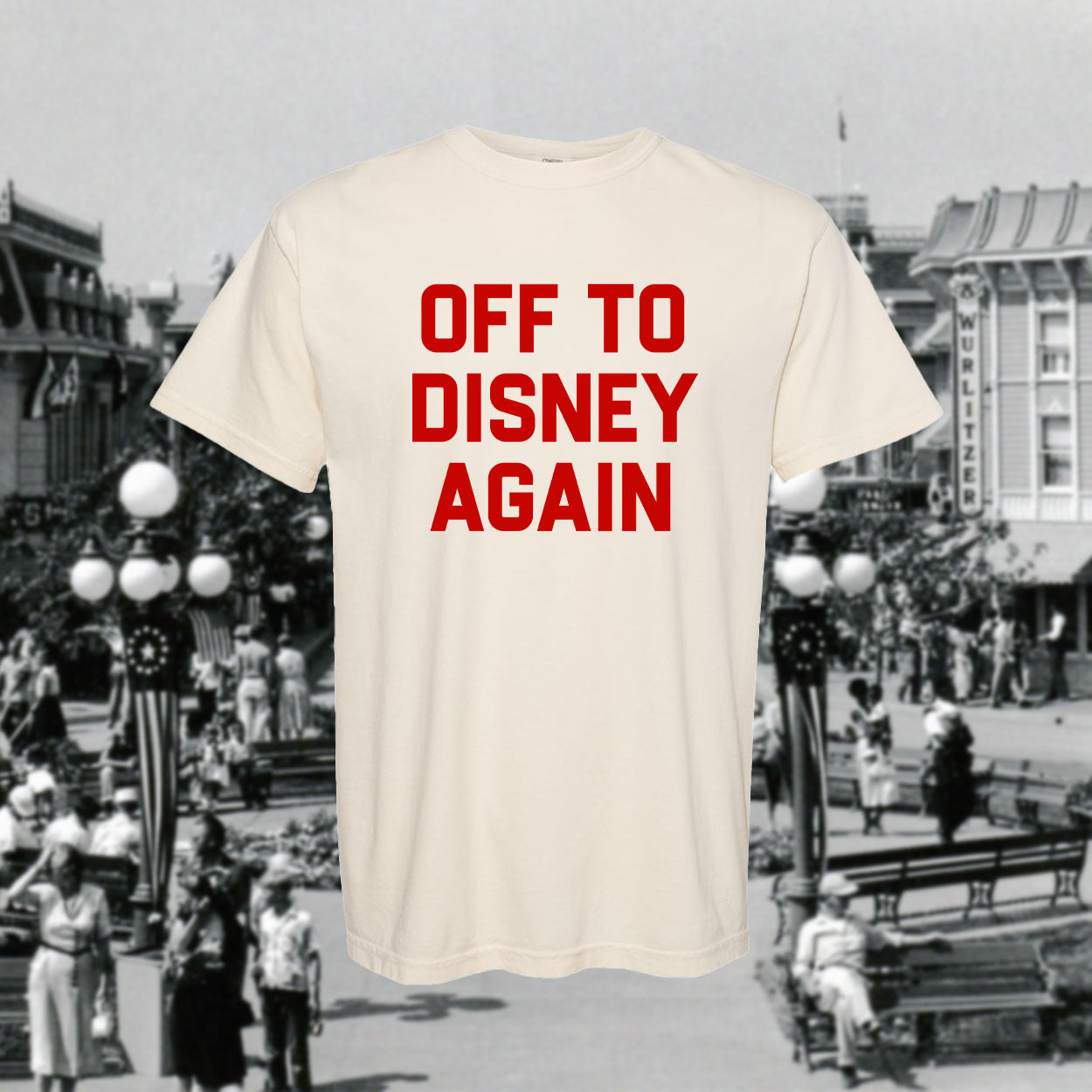 Beige t-shirt with 'OFF TO DISNEY AGAIN' text over a black and white background of a Disney theme park.