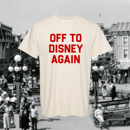 Beige t-shirt with 'OFF TO DISNEY AGAIN' text over a black and white background of a Disney theme park.